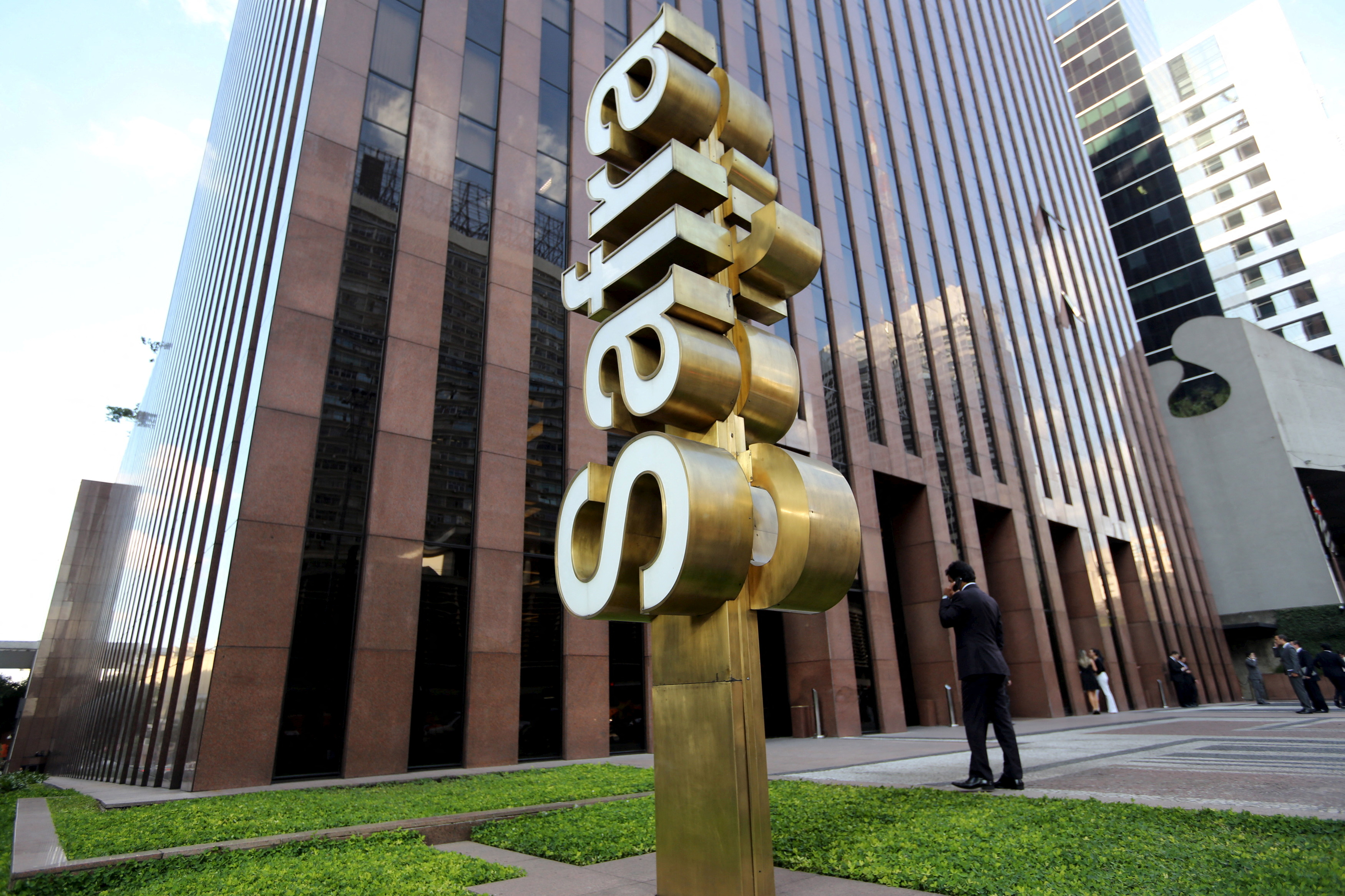 FILE PHOTO: A man walks in front of the Banco Safra SA headquarter in Sao Paulo March 26, 2015. REUTERS/Paulo Whitaker/File Photo
